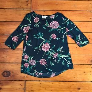 Floral print 3/4 length top with pink and green flowers.